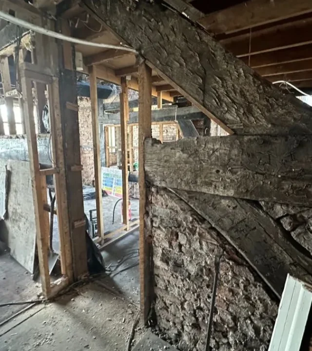 Historic timber frame and brickwork exposed during opening-up at the Angel Inn, Stockport.